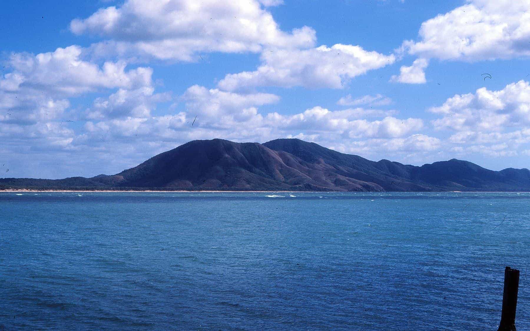 The wide mouth of the Endeavour River meeting the sea at Cooktown, with forested hills behind