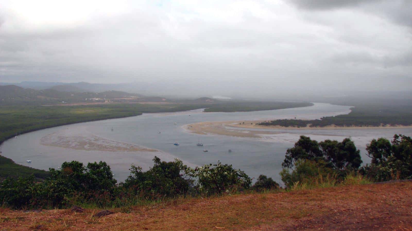 The calm Endeavour River winding between mangrove-lined banks and green hills